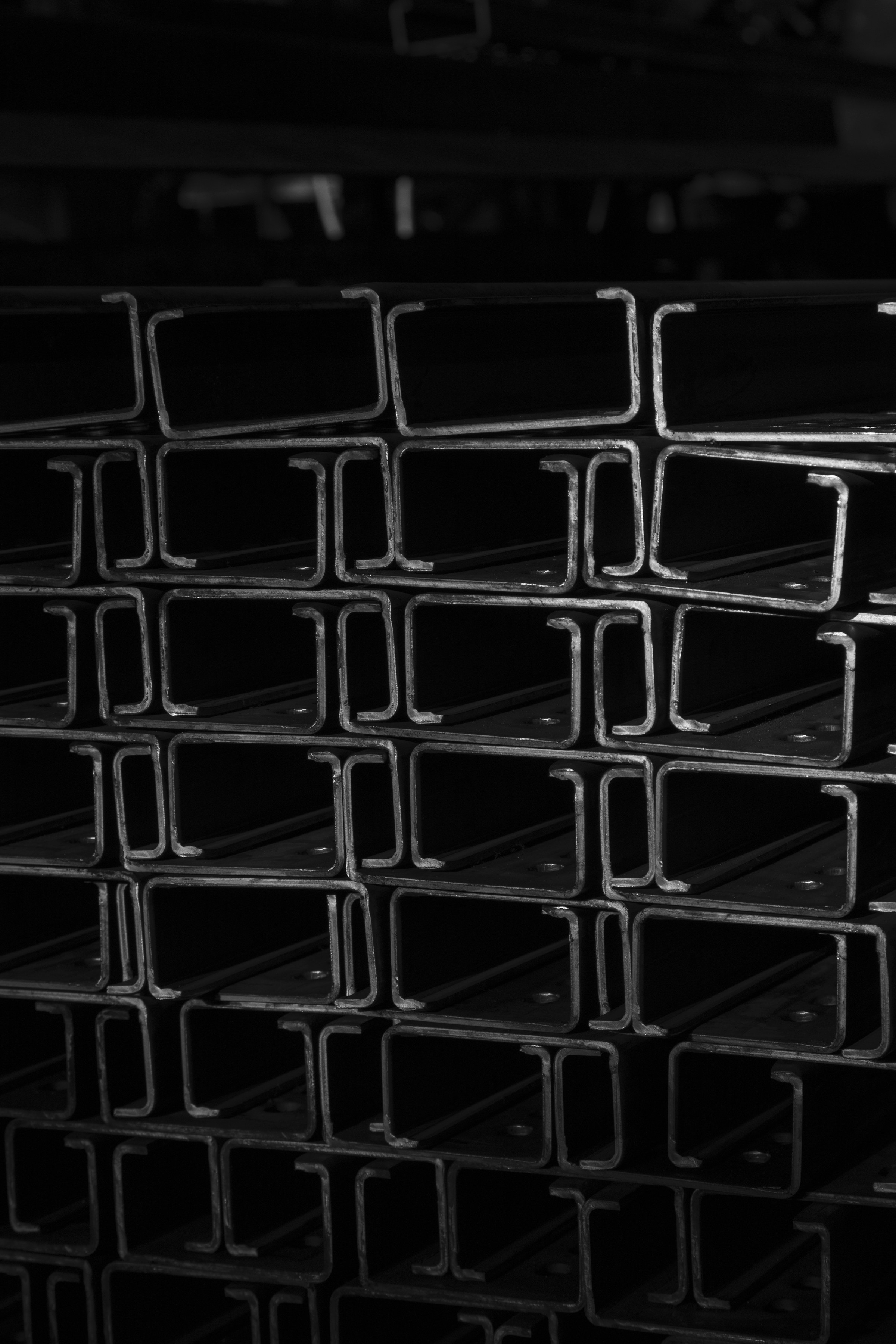 Stacked steel sections showing their cut ends.