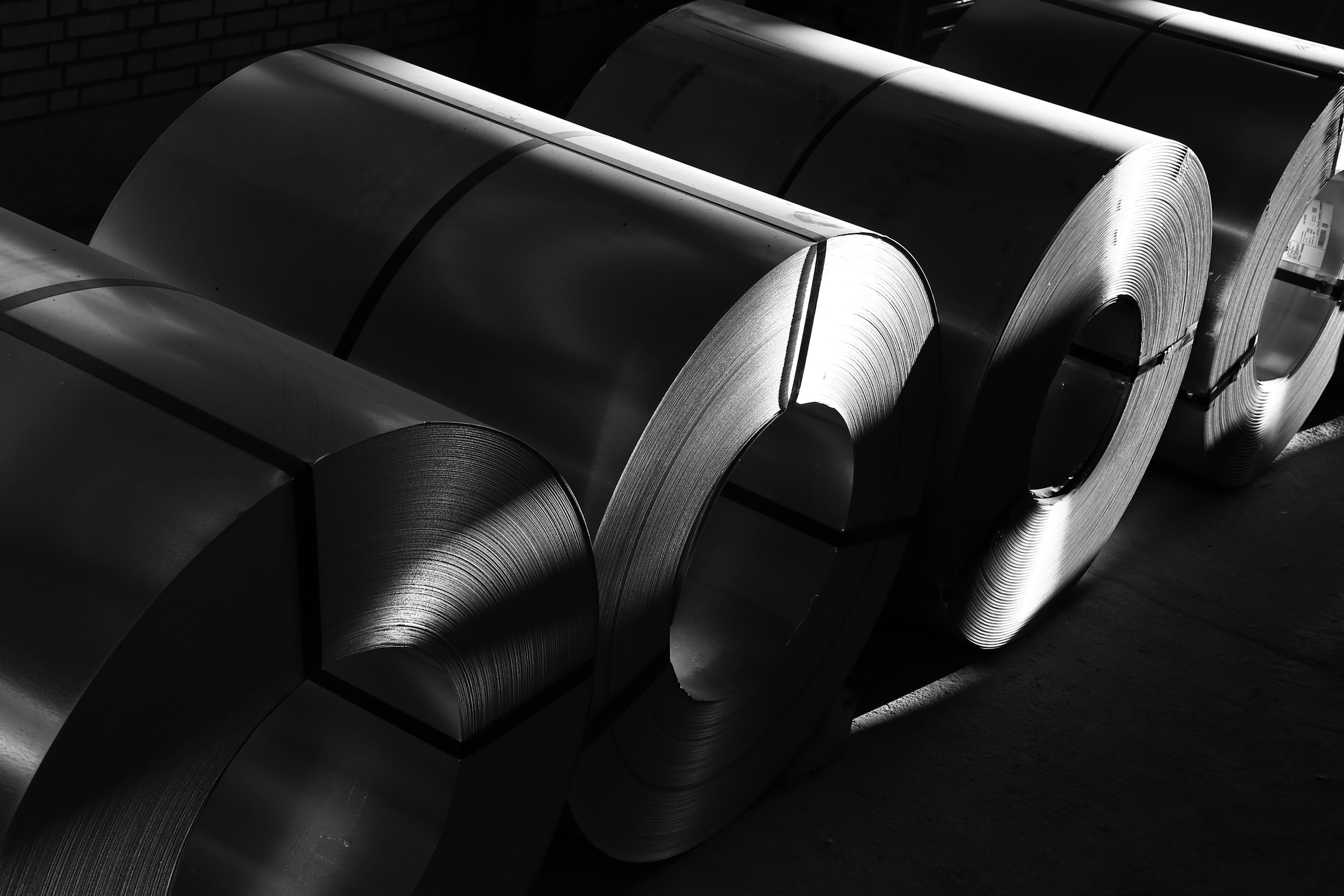 Rolls of sheet steel in an industrial setting.